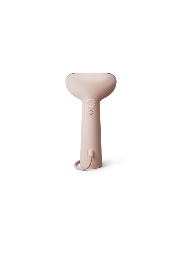 Pink handheld steamer on a white background