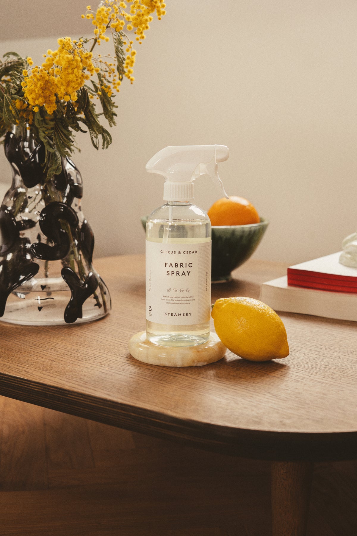 Fabric spray with lemon leaning on it
