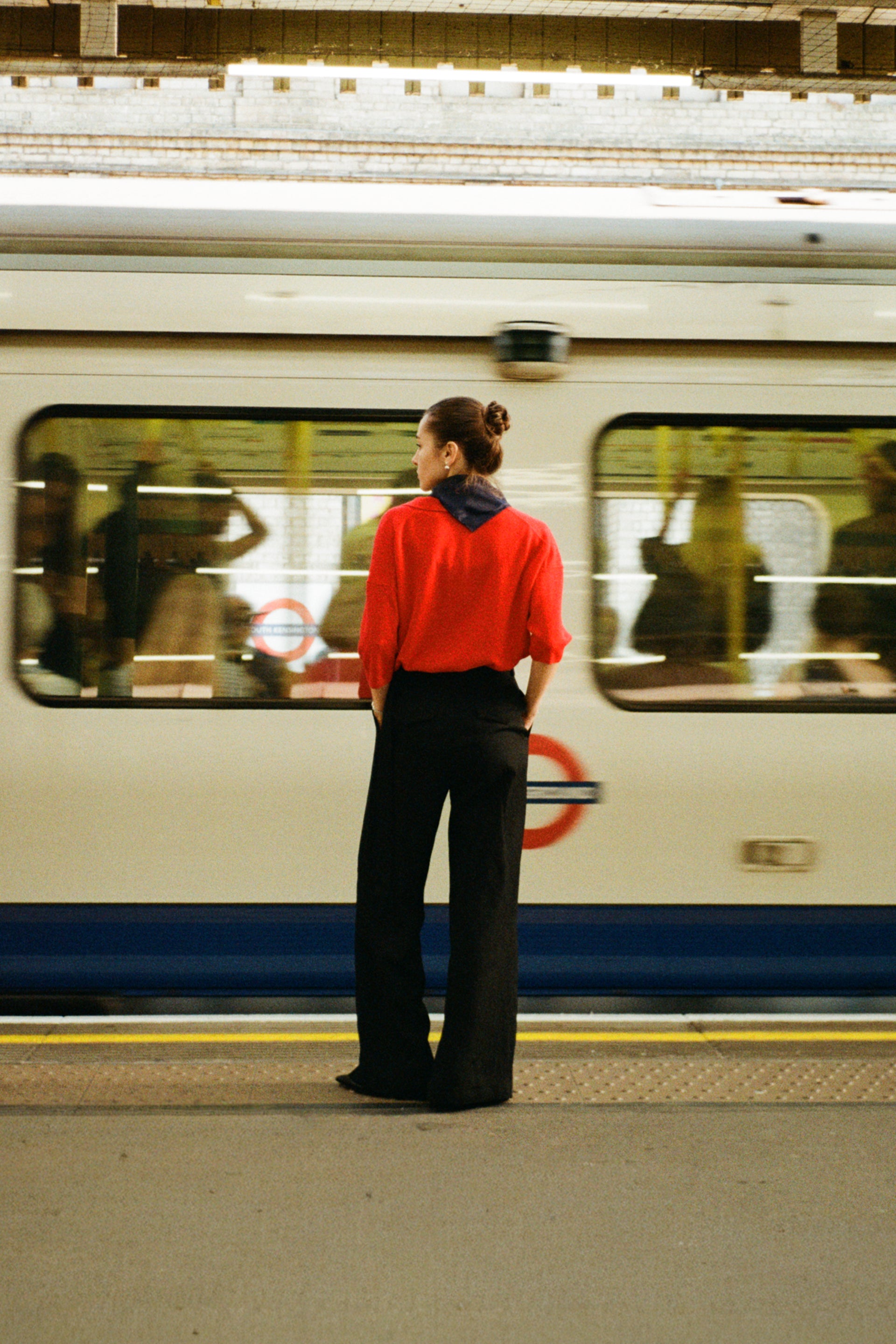 woman wearing red infront of moving train