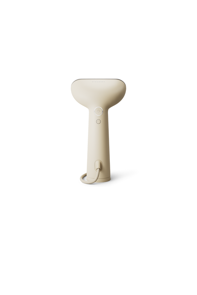 Beige handheld steamer on a white background