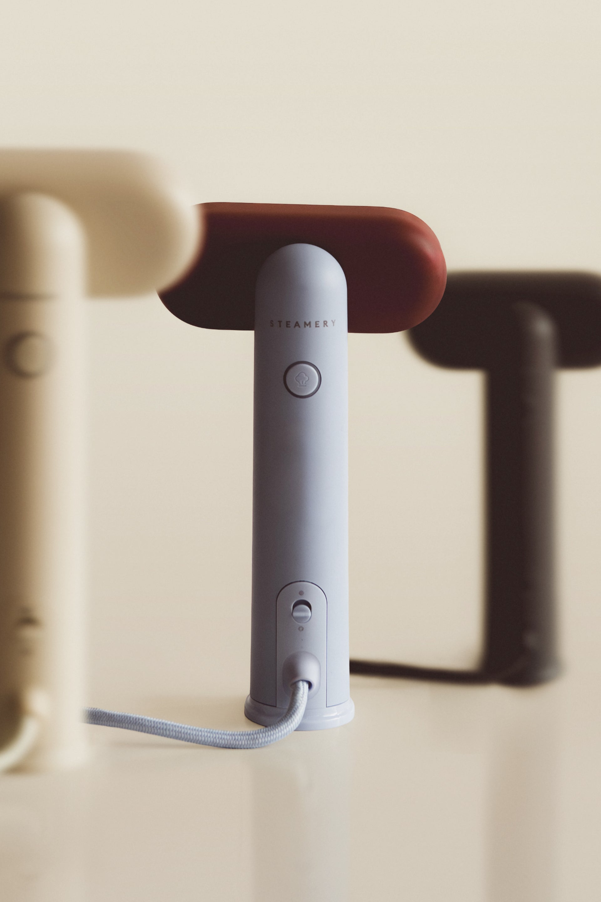 three travel steamers in a row on a beige background