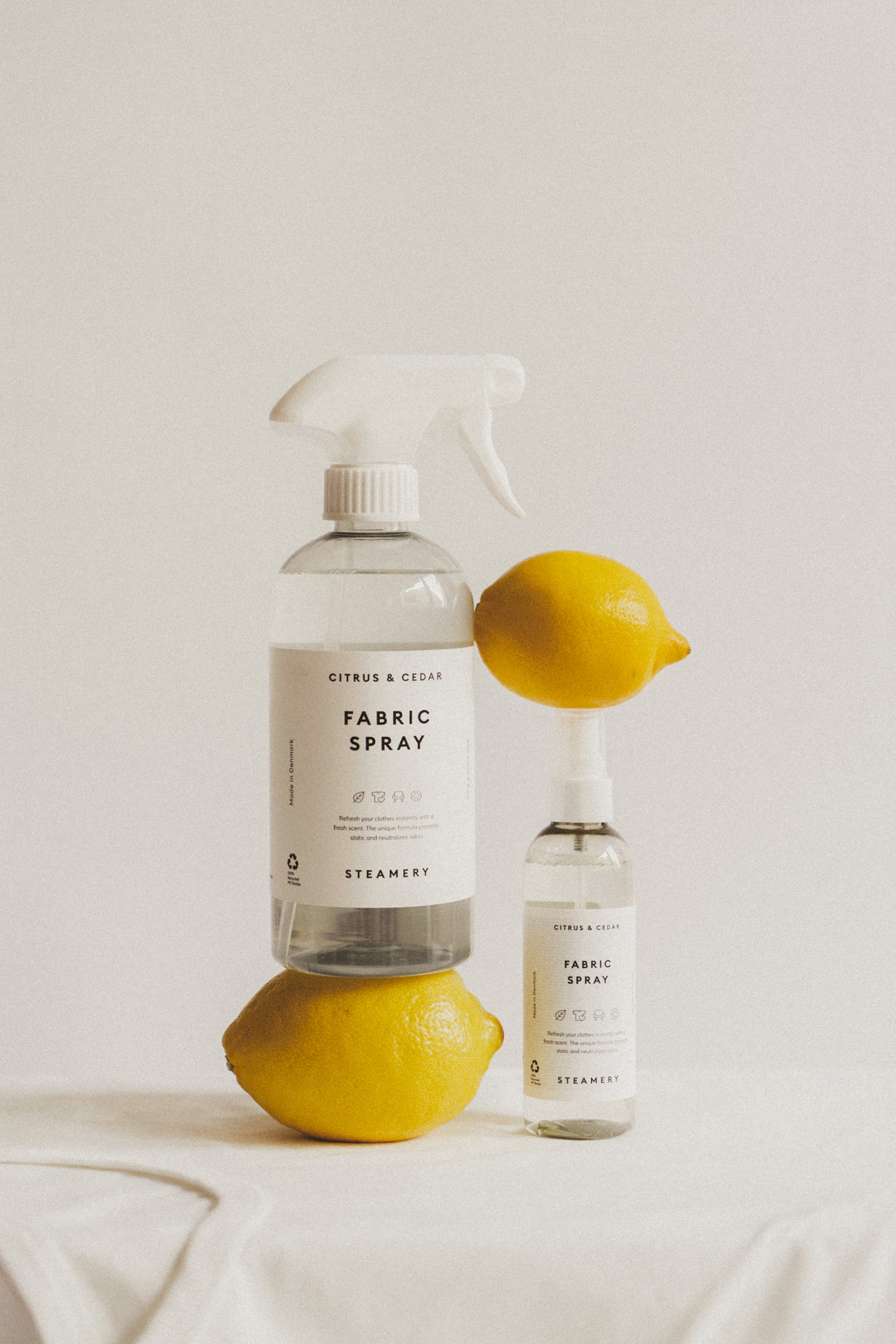 Fabric spray bottle with lemons on a light background