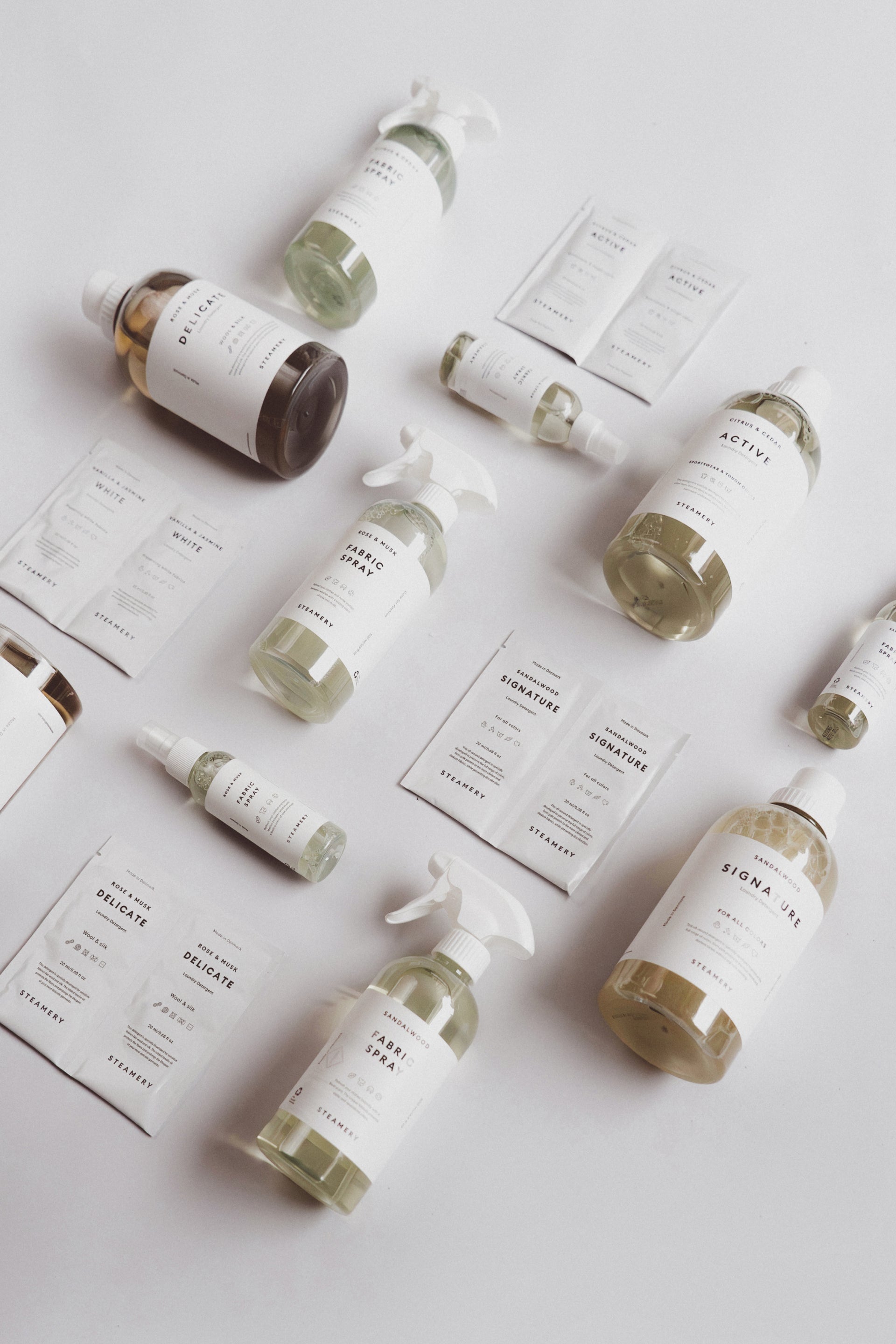 Various laundry products with labels on a light gray background