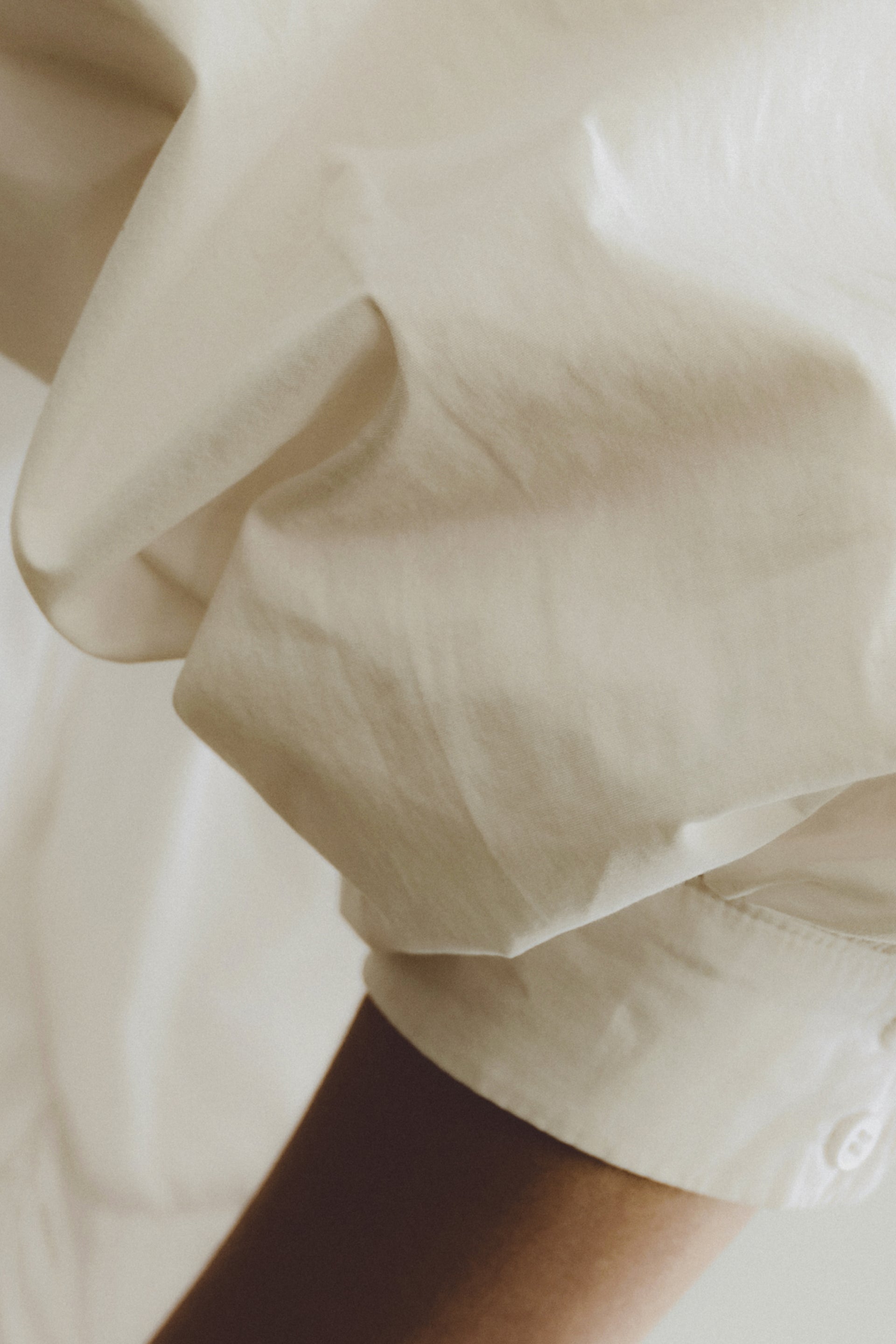 white shirt sleeve and an arm